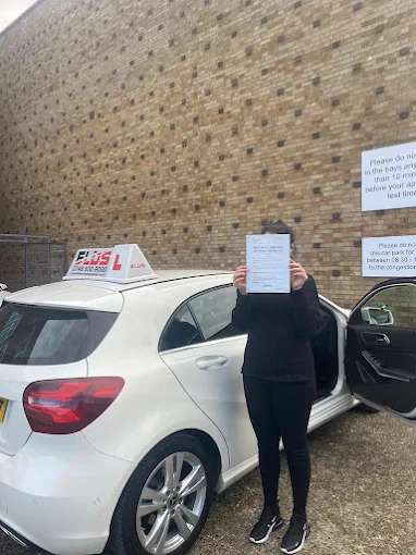 Learner driver celebrating with their instructor after the practical test