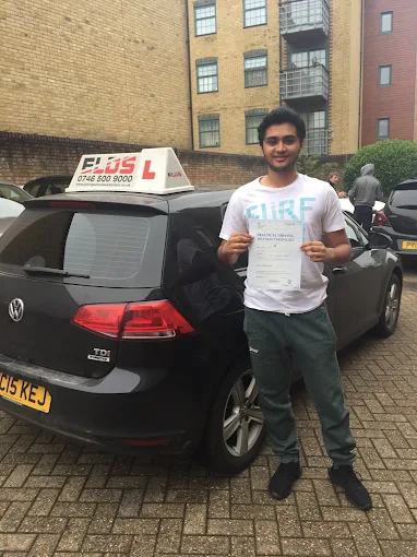 Newly qualified driver smiling with their driving test pass certificate
