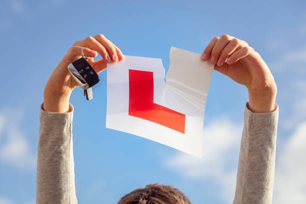 A newly passed driver tearing up their L-plate